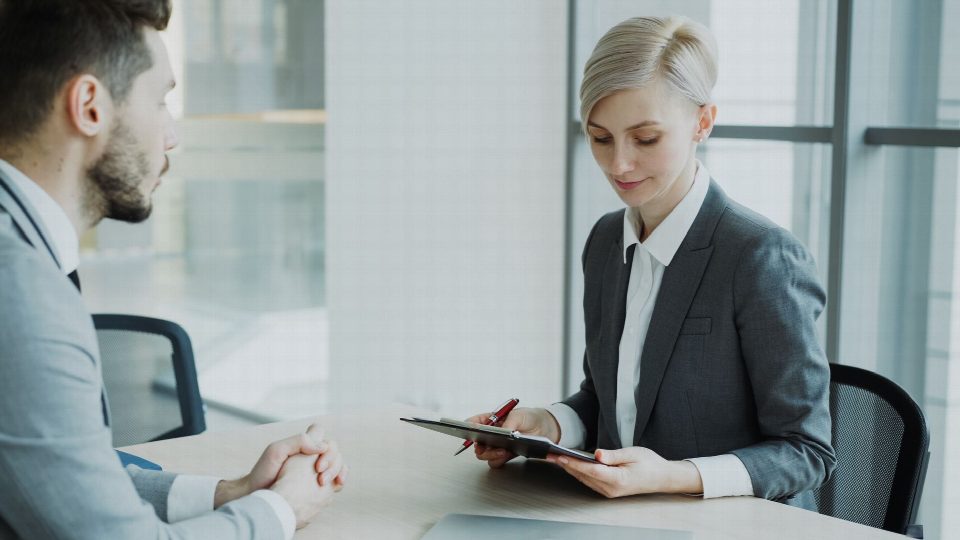 Two professionals in a modern office discussing business. Bright, professional setting. Two professionals in a modern office discussing business. Bright, professional setting.